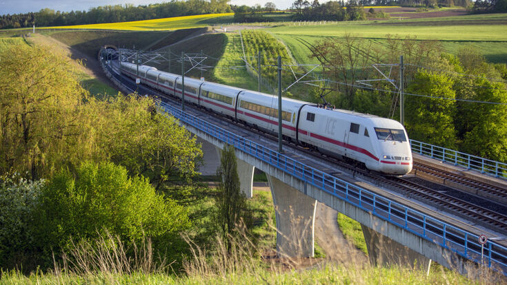 © griangraf - stock.adobe.com german landscape with train deutsche bahn german train transport travel railway transportation german germany rail railroad journey locomotive technology track fast train public transport in germany european trip speed nature landscape business wagon engine blue road carriage architecture people tourism express deutsche electric white bahn db scenic historic summer bavaria bahn train german fast train germany in spring germany and transport german system of transport system of rapid transport train